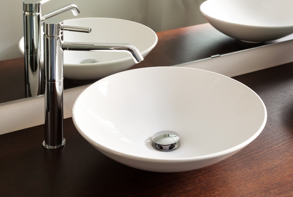 Modern bathroom sink with visible drain plug, ideal for tutorials on how to remove a stuck sink stopper, fix a slow-draining sink, or perform DIY sink drain cleaning—Neighborhood Plumbing offers expert sink repair and drain cleaning services. Call us today for help with how to remove bathroom sink drain plug, how to fix stuck sink stopper, remove pop-up drain plug, sink stopper removal tool, bathroom sink plug won’t come out, how to clean sink drain plug, clogged sink drain plug removal, sink drain plug removal near me, drain stopper stuck closed, how to replace a sink drain plug, drain cleaning service near me, plumbing repair near me, sink repair service, bathroom plumbing repair, slow draining sink fix, local plumber for sink clog, emergency drain cleaning, remove drain stopper without tool, sink unclogging near me, pop-up drain repair, how to remove push button sink stopper, plumber to remove drain plug, sink plug repair service, Neighborhood Plumbing drain cleaning services, professional sink plumbing repair.