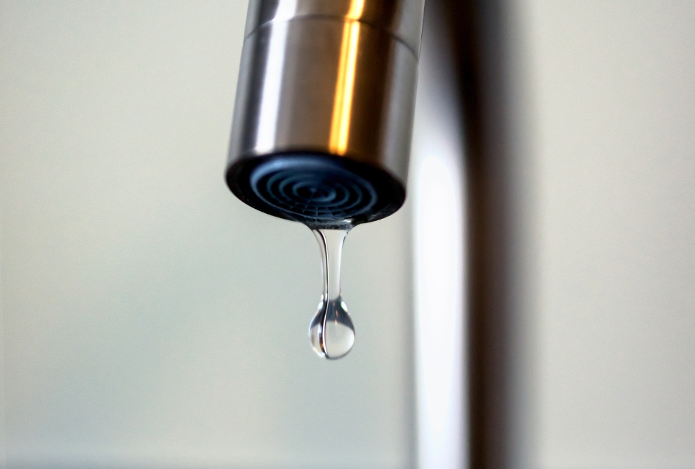 Leaky faucet being repaired by a plumber, illustrating how to fix a leaky faucet, stop dripping taps, and perform faucet repair services, with professional plumbing solutions from Neighborhood Plumbing in Salt Lake City, Sandy, Ogden, Layton, Bountiful, and Clearfield, UT. Reach out to us today for help with how to fix a leaky faucet, leaky faucet repair, dripping faucet repair, stop a faucet from leaking, fix a dripping tap, faucet replacement, leaking tap repair, faucet repair services, faucet maintenance, leaky sink faucet, leaking kitchen faucet, bathroom faucet repair, plumbing repair for faucets, fix a leaky faucet near me, faucet service near me, plumbing company for faucet repair, professional faucet repair, emergency faucet repair, replace faucet washer, fix slow leaking faucet, repair running toilet and faucet.